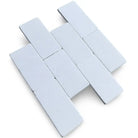 White rectangular tiles in herringbone pattern from Thassos Supreme 3X6 Marble Tumbled