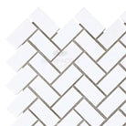 White herringbone tile pattern in Thassos Supreme 5/8X1 1/4 Herringbone Mosaic Marble