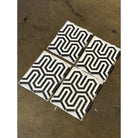 Four black and white patterned tiles from Thassos Supreme Berlinetta Marble Mosaic