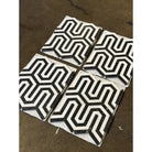 Four black and white patterned tiles from Thassos Supreme Berlinetta Design mosaic