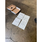 Geometric patterned tiles with a cardboard box for Thassos Supreme Berlinetta Mosaic Marble
