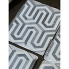 Geometric patterned tile squares in Thassos Supreme Berlinetta Mosaic Marble with Blue-Gray finish