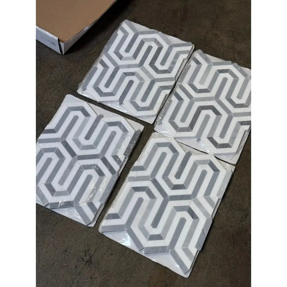 Four geometric patterned tiles from Thassos Supreme Berlinetta Blue-Gray Mosaic Marble