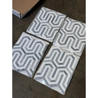 Four geometric patterned tiles from Thassos Supreme Berlinetta Blue-Gray Mosaic Marble