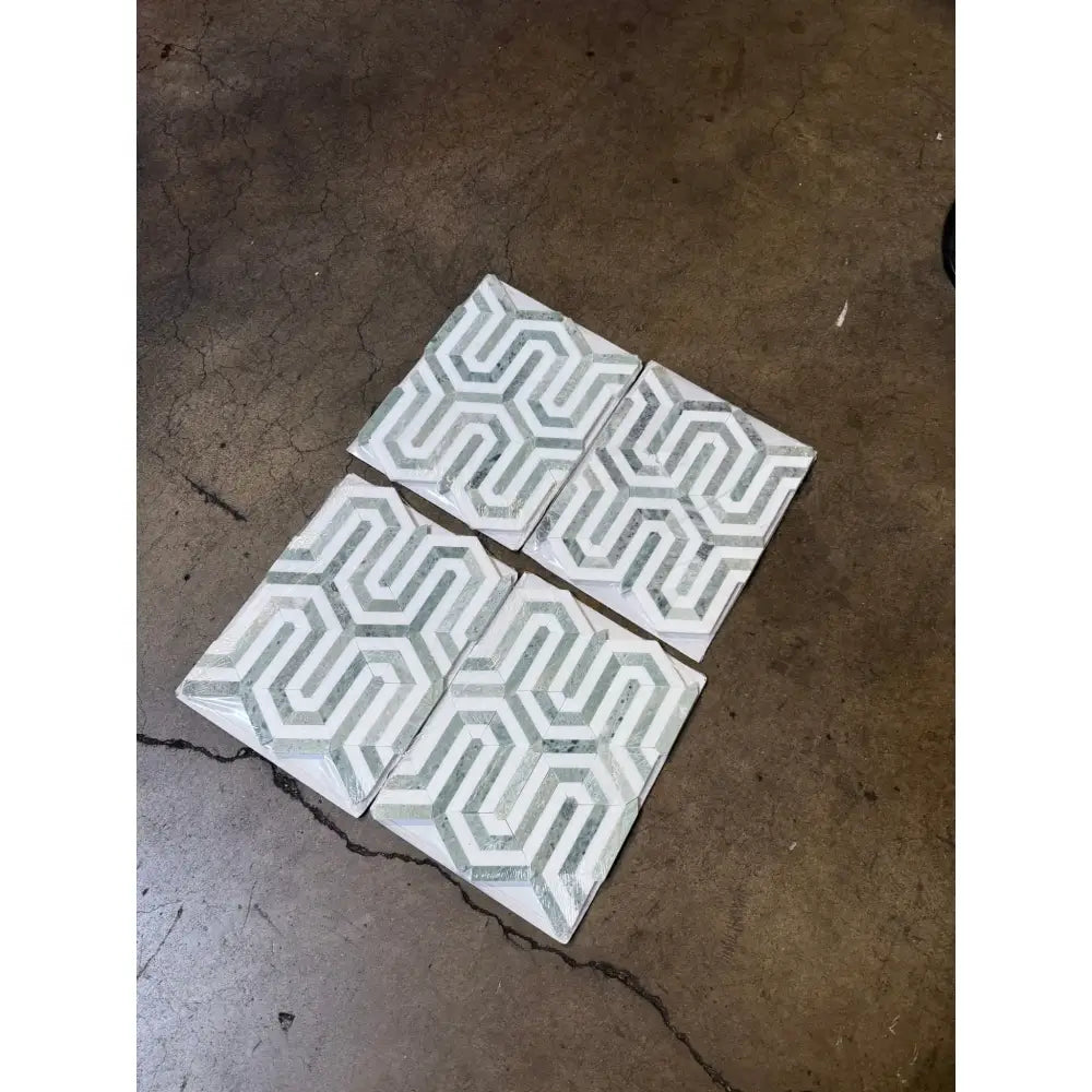 Geometric patterned tiles in Thassos Supreme Berlinetta design with Ming-Green accents