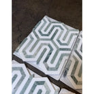 Hexagonal patterned marble tiles in Thassos Supreme Berlinetta Mosaic with Ming Green finish