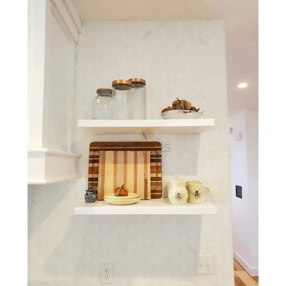 White shelves with kitchen items displayed on Thassos Supreme Pinwheel Mosaic with Blue-Gray marble