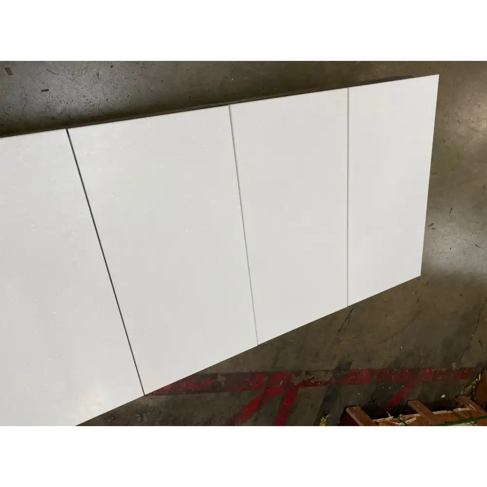 White cabinet doors in Thassos Supreme Pinwheel Mosaic with Blue-Gray marble finish