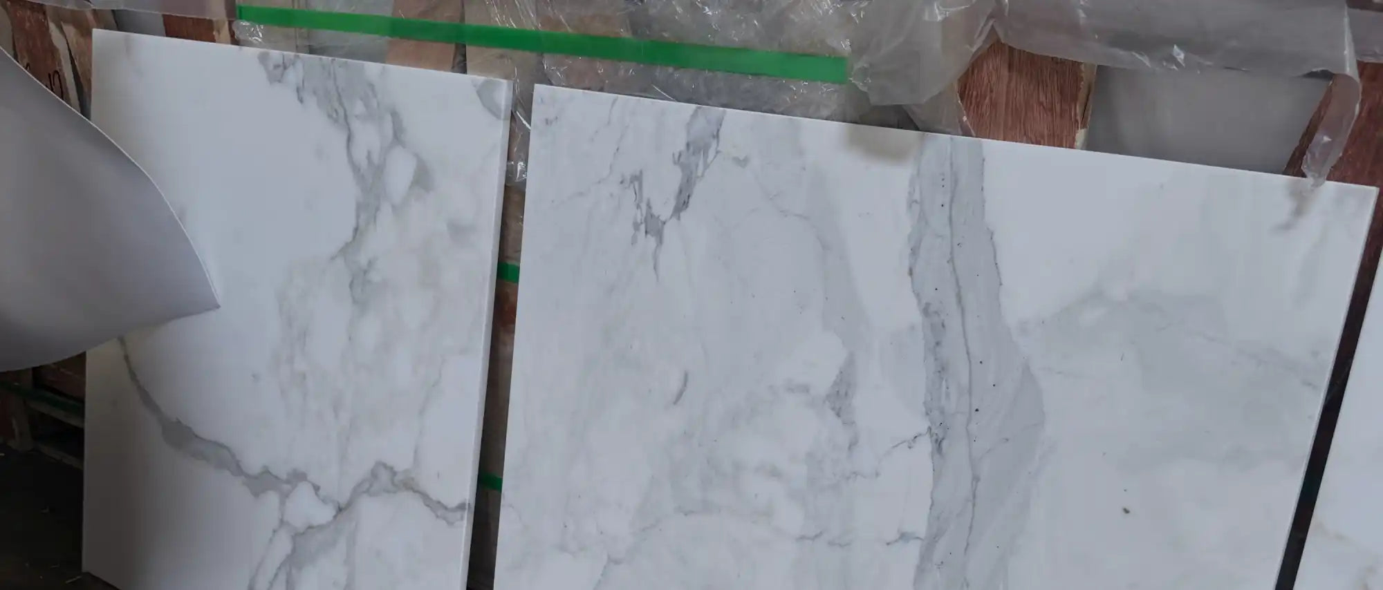 White marble-look tiles with grey veining.